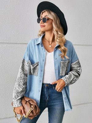 Denim overshirt with leopard print sleeves and pockets, buttoned front, collared neckline.