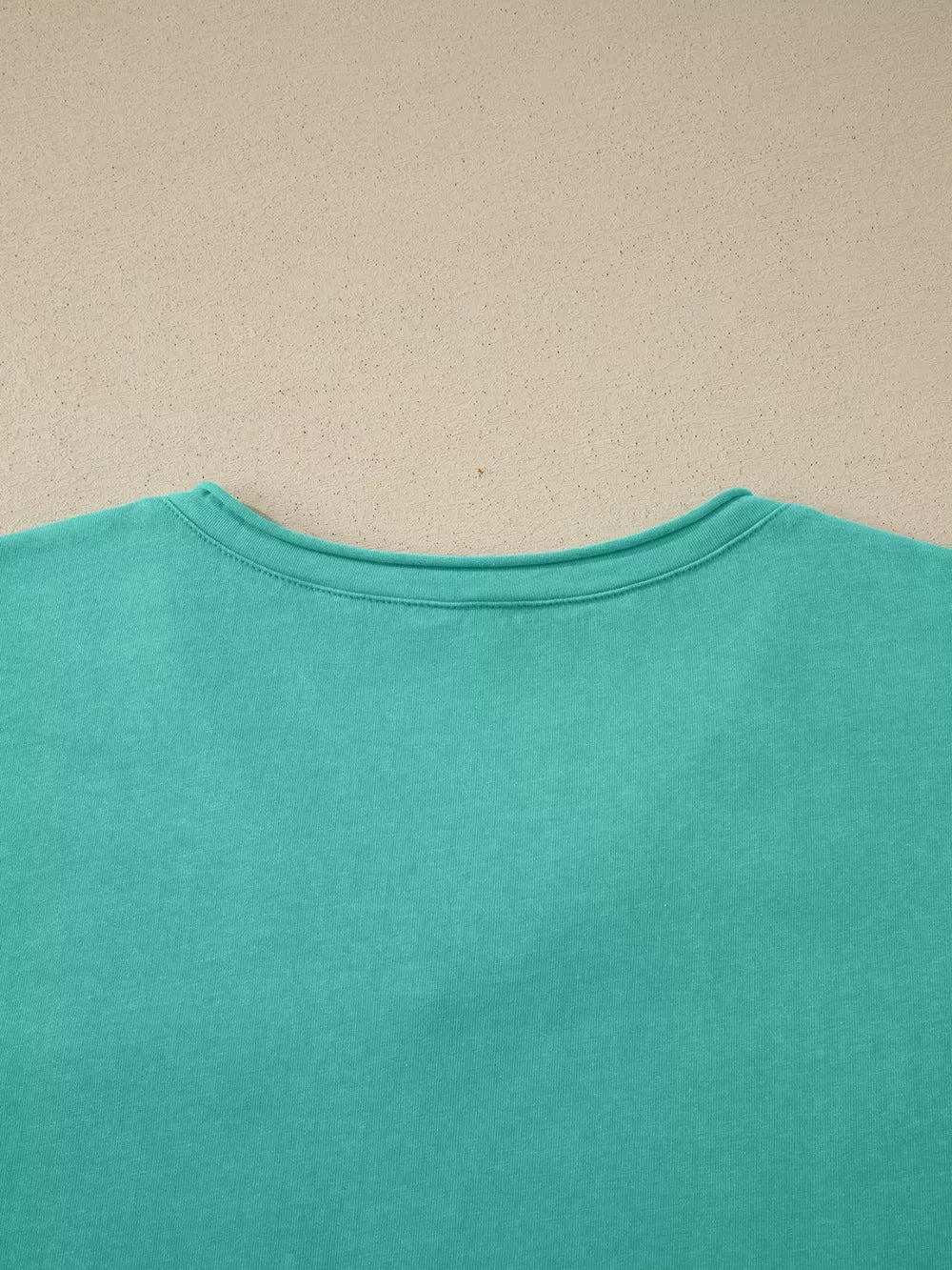 Mineral wash teal cotton maternity t-shirt with crew neck and short sleeves.