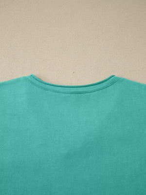 Mineral wash teal cotton maternity t-shirt with crew neck and short sleeves.