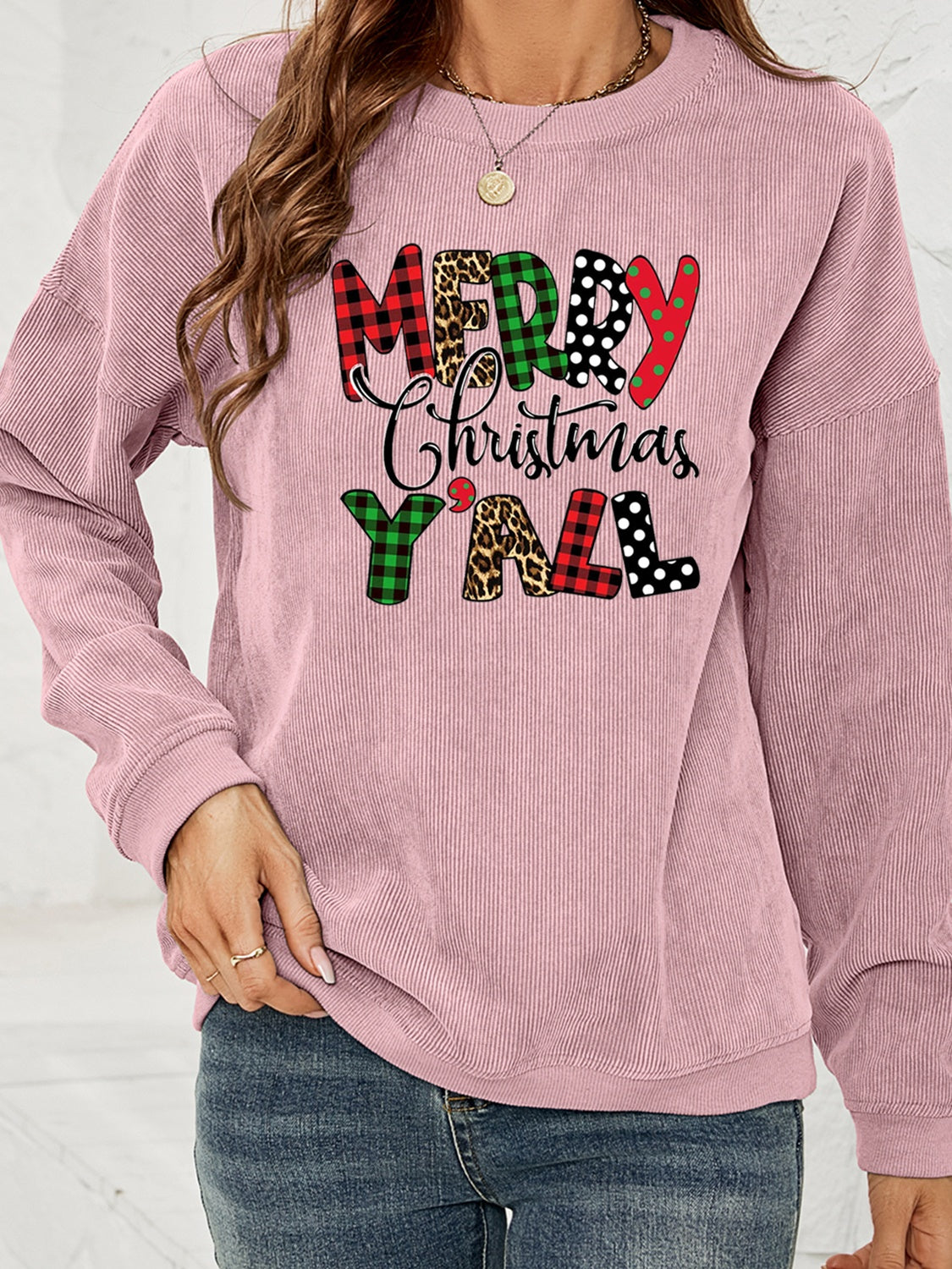 Dusty Pink corduroy sweatshirt with Merry Christmas Y'all graphic in buffalo plaid, leopard, and polka dot patterns.