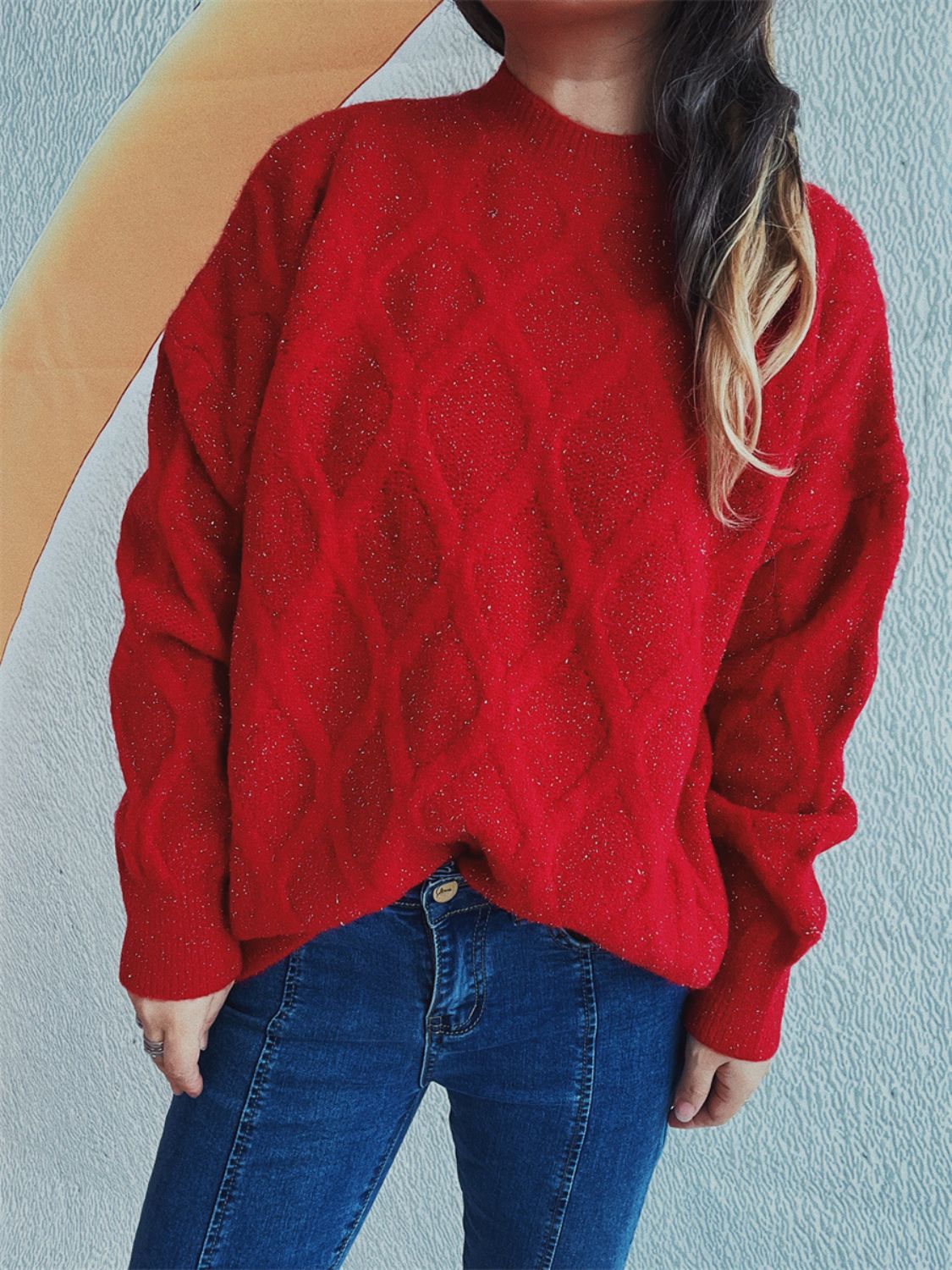 Red sparkle knit sweater with diamond pattern and relaxed fit.