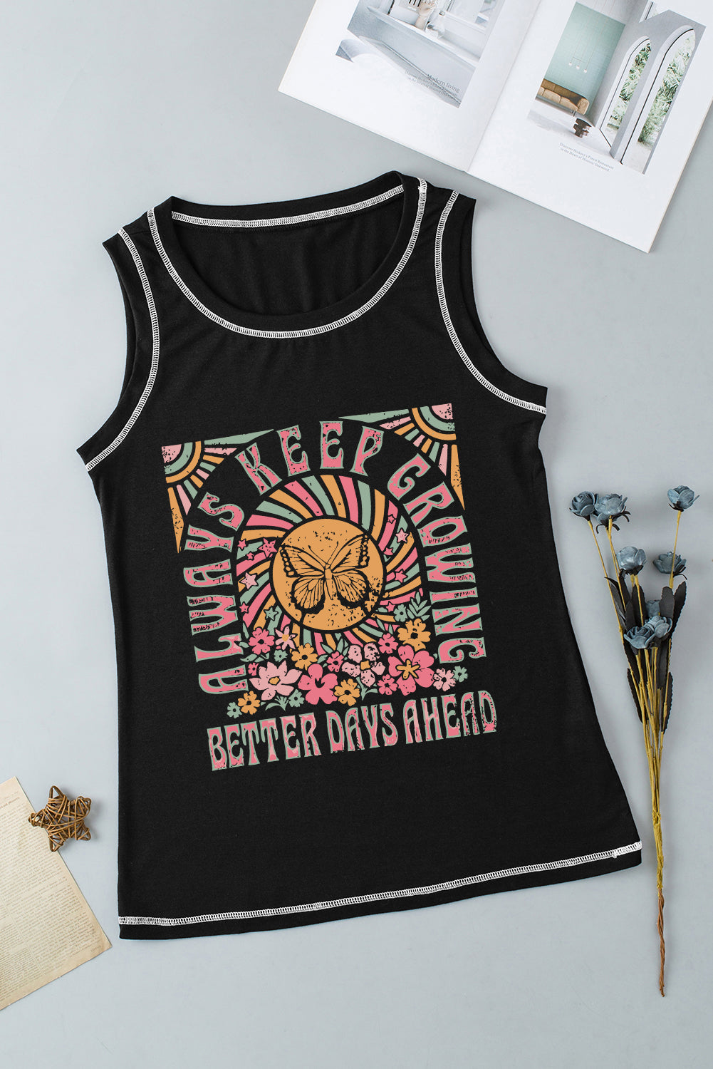 Black graphic tank top with contrast stitching and a retro floral butterfly design.