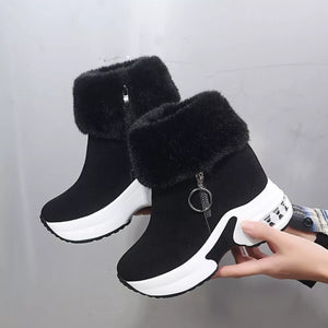 Black plush side-zipper ankle boots with white platform soles and fur trim.