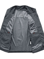 Grey men's utility vest with mesh lining and multiple pockets.