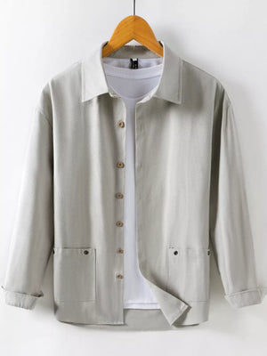 Light gray cotton button-up shirt with two chest pockets and long sleeves.
