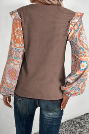 Brown knit top with ruffled printed sleeves and a boho pattern.