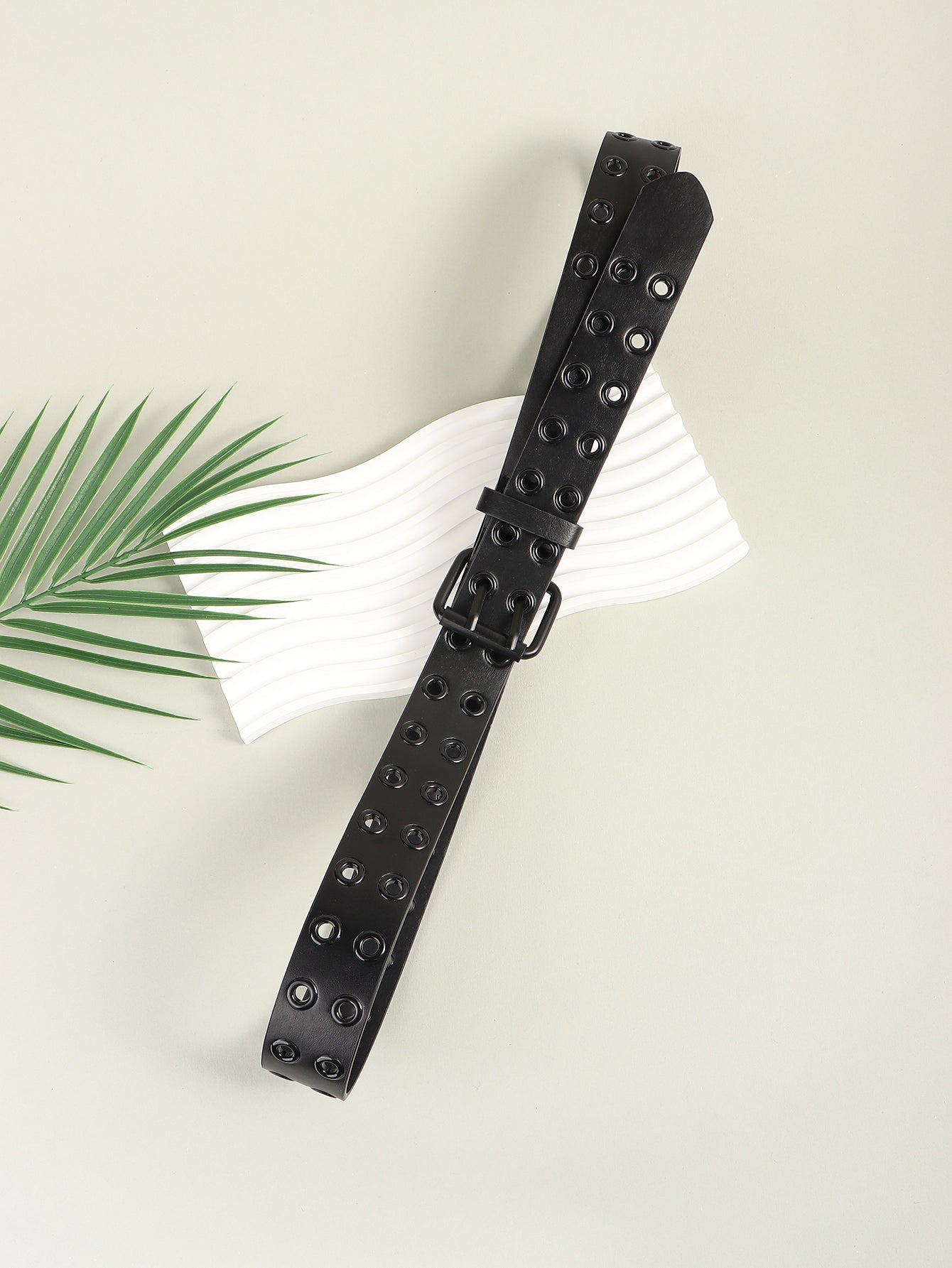 Black vegan leather belt with double grommet detail and black alloy buckle.