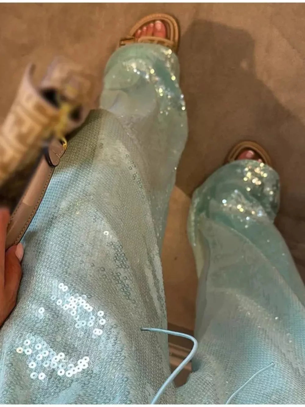 Light blue wide leg sequin pants with drawstring detail.