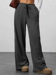 Dark gray ribbed wide-leg pants with drawstring waist and pockets.