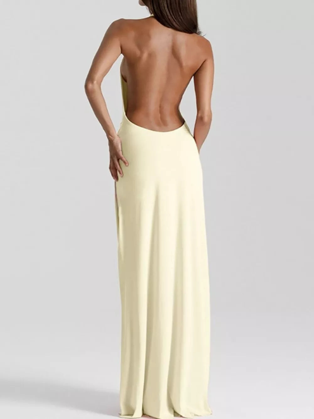 Yellow ruched maxi dress with a dramatic open back and halter neckline.