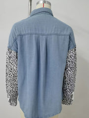Denim shirt with leopard print sleeves, button-up style, and pockets.