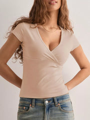 Apricot crossover ruched fitted t-shirt with short sleeves and a deep V-neck.