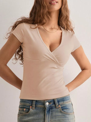 Apricot crossover ruched fitted t-shirt with short sleeves and a deep V-neck.