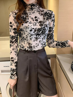Sheer floral mock neck t-shirt with ruffled cuffs in black and white.