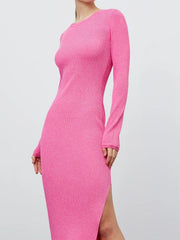 Ribbed midi dress in hot pink with a high slit and long sleeves.
