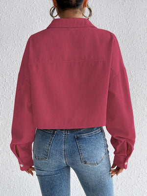 Cropped corduroy jacket in cerise with snap front and button cuffs.