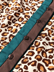 Leopard print button-down shirt with teal and brown paneling and dark buttons.