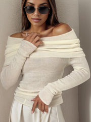 Ivory knit sweater with off-the-shoulder neckline and long sleeves.
