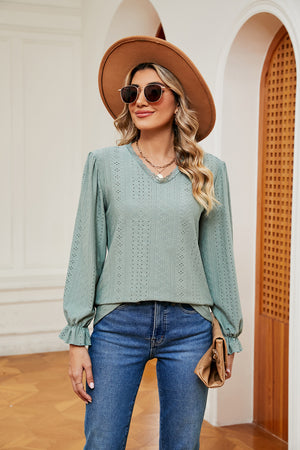 Perforated sleeve blouse in Gum Leaf green with ruffle cuffs and V-neckline.