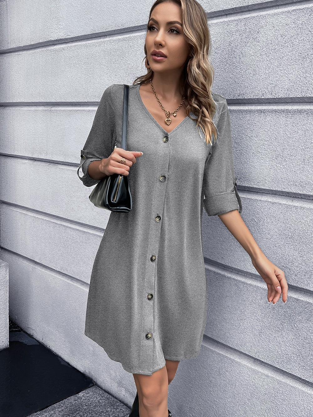 Light gray button-down mini dress with V-neck and cuffed sleeves.