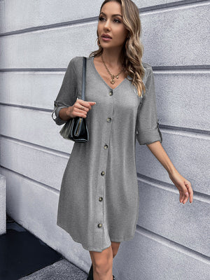 Light gray button-down mini dress with V-neck and cuffed sleeves.