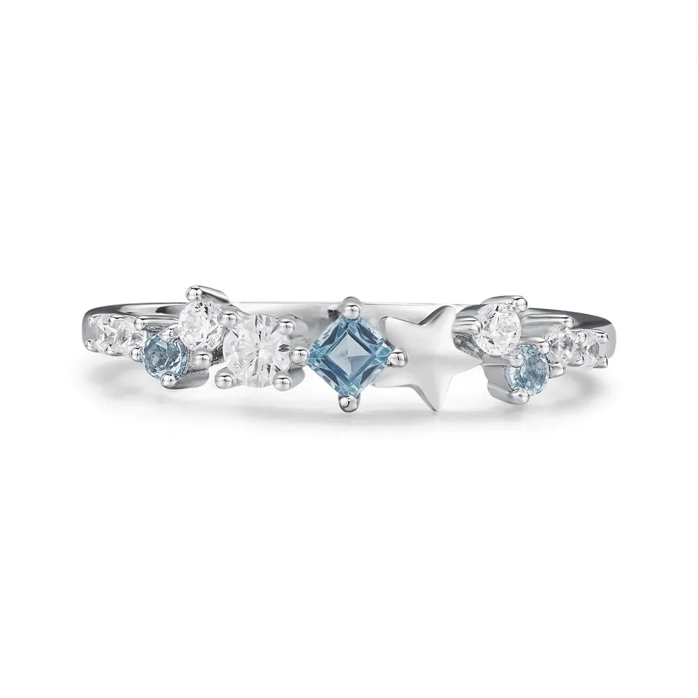 Silver ring with celestial cluster of blue and clear cubic zirconia stones and star accents.
