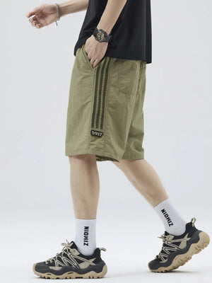 Khaki casual drawstring shorts with sporty stripes and a number detail.