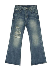 Distressed flare leg jeans in medium wash denim with ripped details.