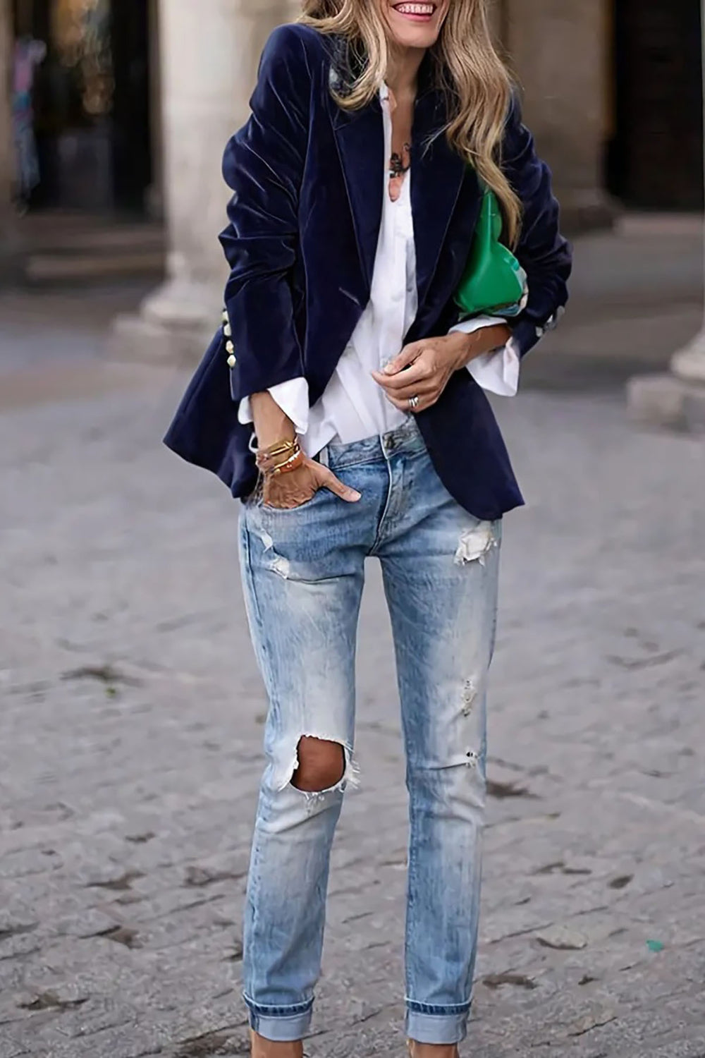 Navy velvet blazer with gold buttons and a chic collar, worn over a white shirt.