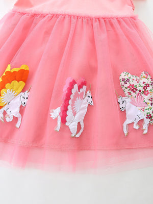 Pink tulle baby dress with embroidered unicorn appliques and floral wings.