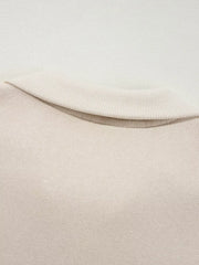 Beige cotton zip-up jacket detail with ribbed collar and comfortable fabric.