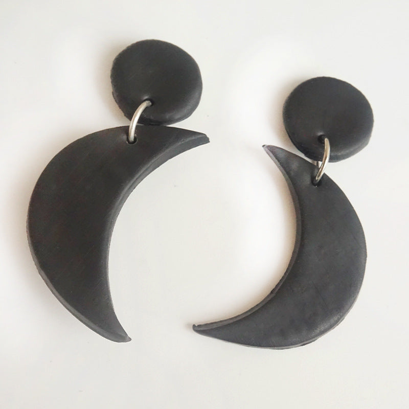 Halloween charm drop earrings in black with crescent moon charms and circular studs.