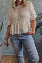 Beige textured blouse with ruffle hemline and short flutter sleeves, button front detail.