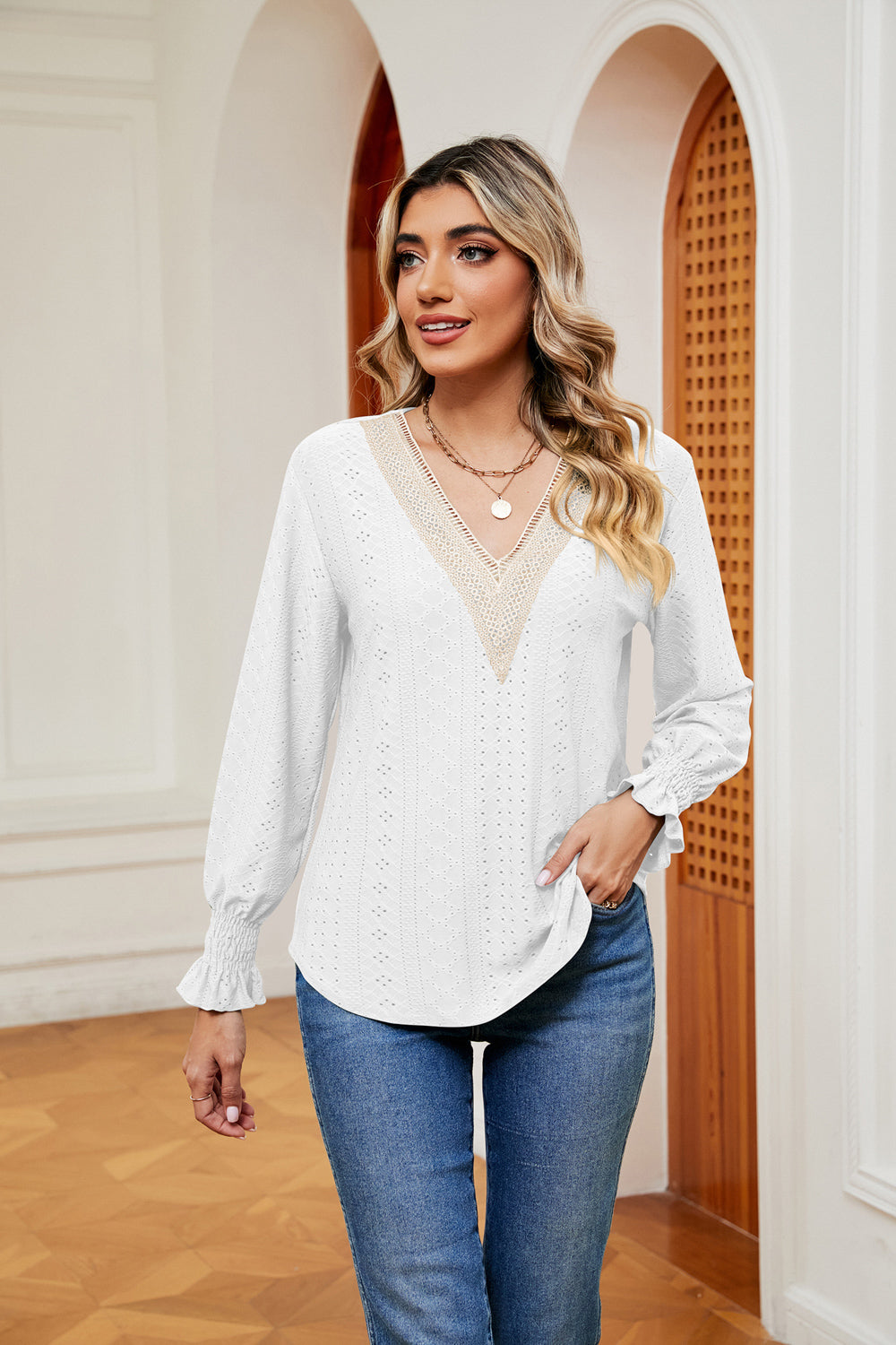 White eyelet blouse with lace V-neck and ruffle cuffs.
