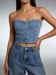 Structured denim tube top with button detail and chest pockets, made of cotton.