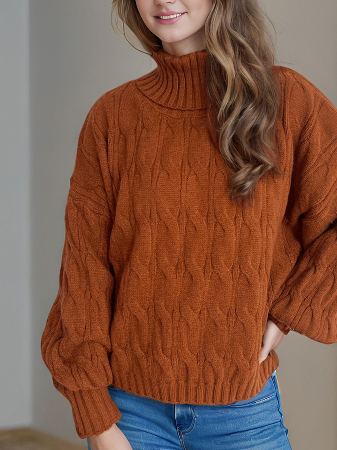 Oversized caramel cable knit turtleneck sweater with ribbed cuffs and hem.