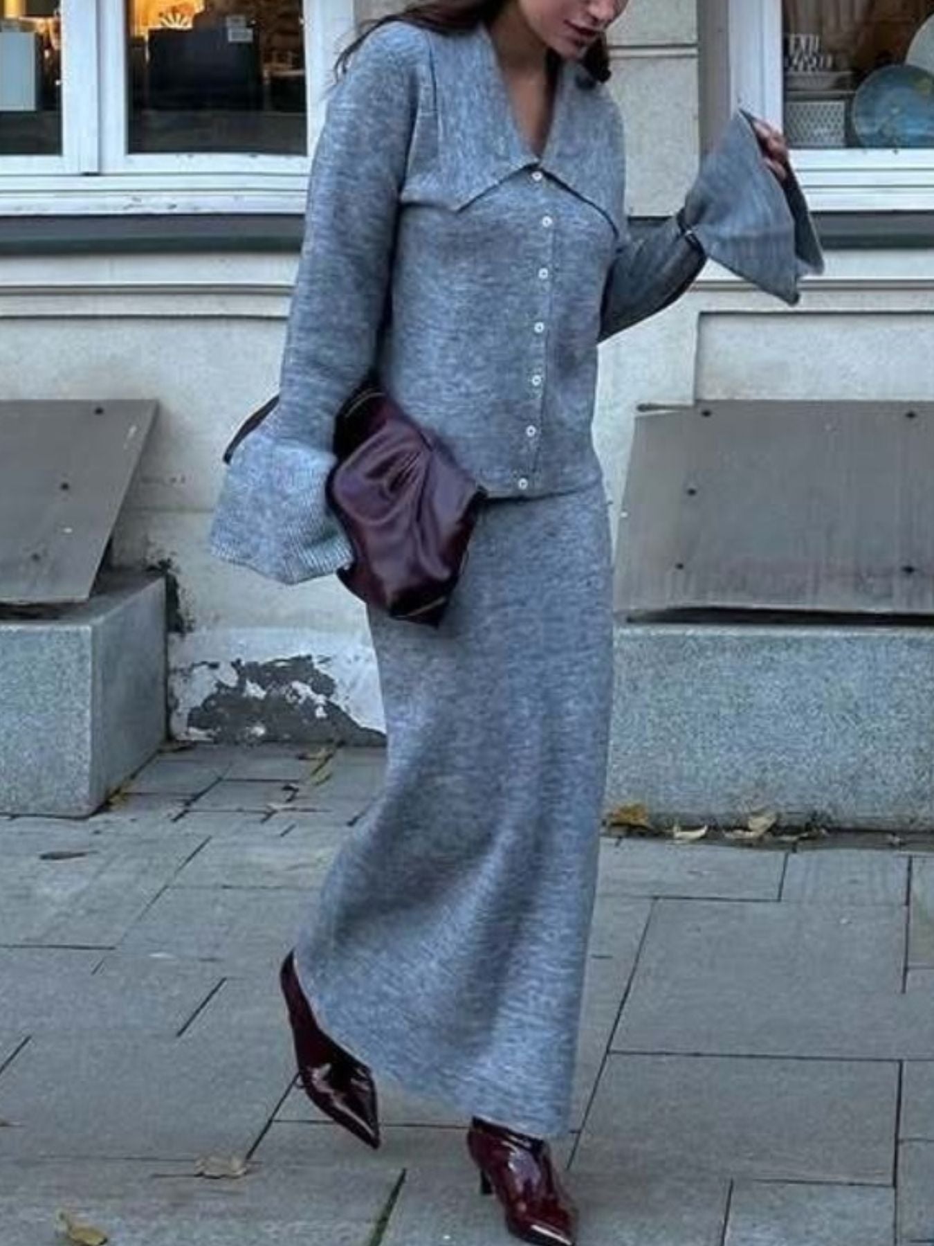 Grey ribbed knit cardigan with button front and bell sleeves, paired with a matching midi skirt.