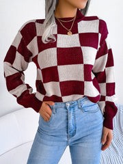 Checkerboard knit mock neck pullover in burgundy and white acrylic with a relaxed fit.