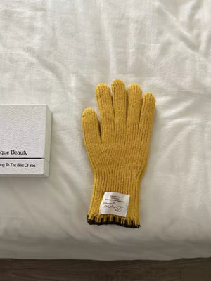 Yellow ribbed knit gloves with scalloped cuff and dark trim detail.