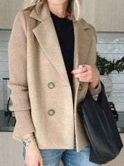 Double-breasted beige wool blend blazer with ribbed knit sleeves and button detail.