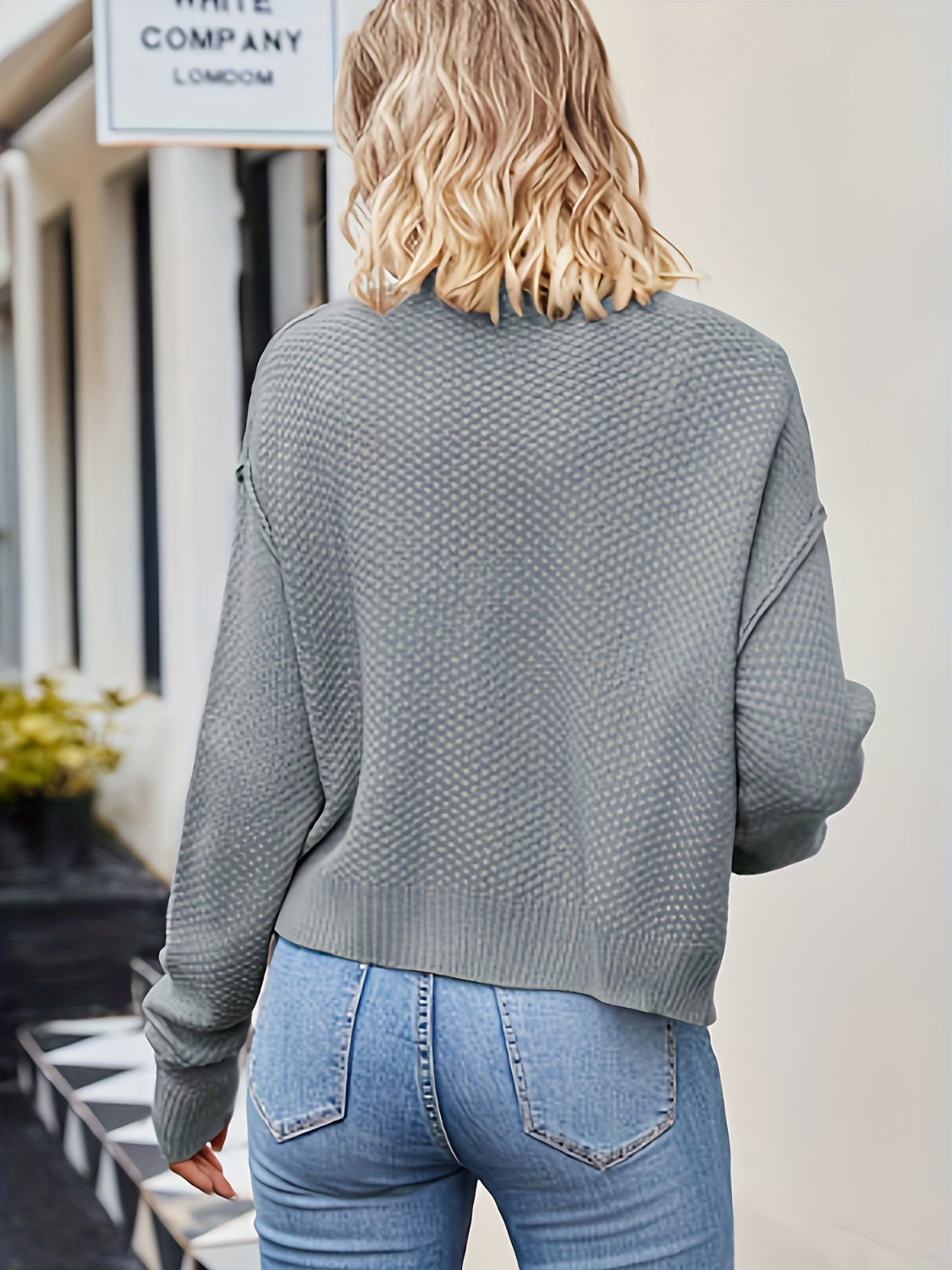 Gray acrylic button cardigan with textured knit and relaxed fit.