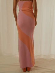 Geometric knit maxi slip dress in pink and orange with diagonal color blocking.