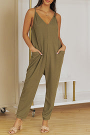 Relaxed-fit jersey jumpsuit in olive green with V-neck, spaghetti straps, and slouch pockets.