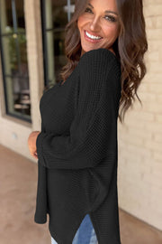 Black waffle knit V-neck sweater with slit hem detail