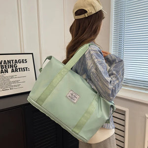 Weekend Escape Nylon Tote in Light Green with dual handles and a shoulder strap.