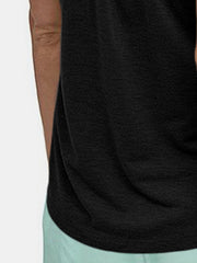 Black racerback tank top with textured fabric and a relaxed fit.