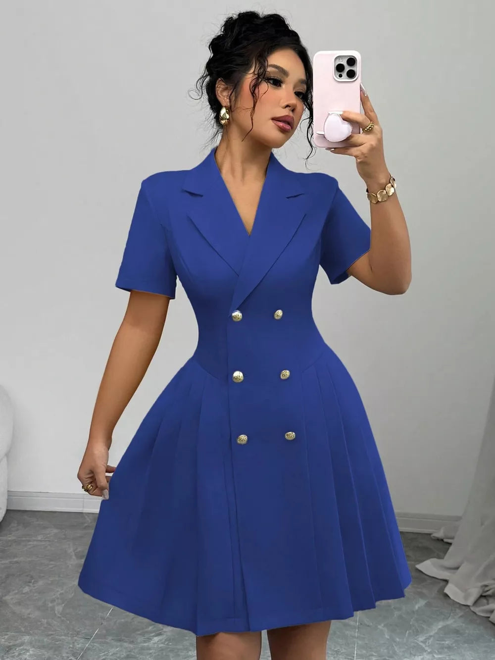 Blue double-breasted pleated blazer dress with gold buttons and short sleeves.