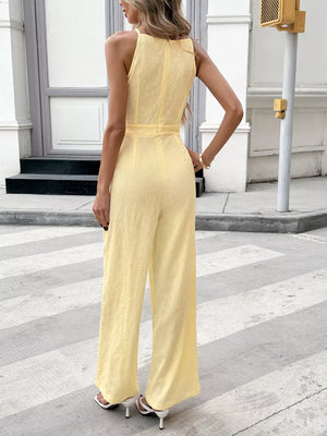 Yellow tie strap wide-leg jumpsuit with subtle floral texture and defined waist.