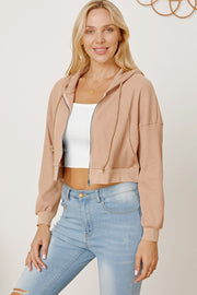 Waffle knit cropped zip hoodie in tan with drawstring hood and ribbed cuffs.