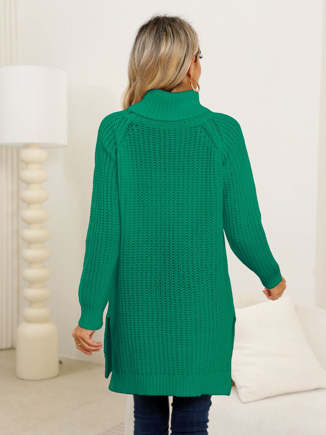 Green ribbed knit turtleneck tunic with side slits.